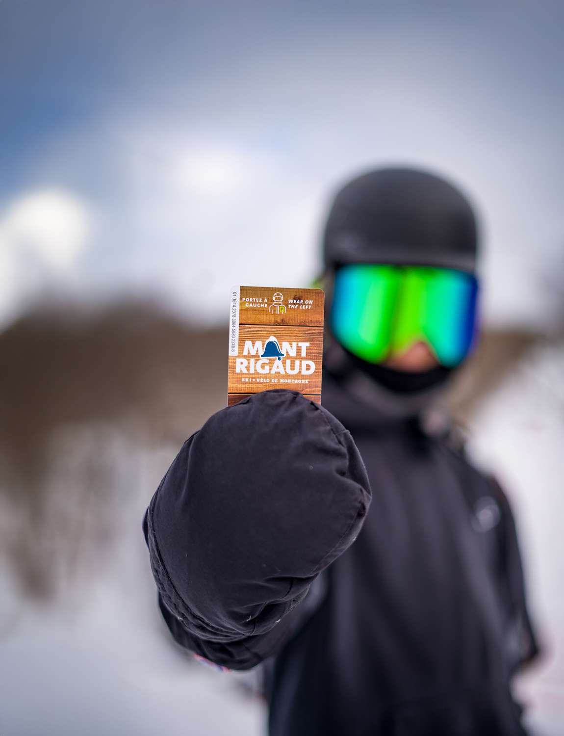 A young snowboarder proudly shows off his rechargeable RFID card — Mont Rigaud, ski resort, snowboarding, alpine skiing, mountain biking, and hiking, family-friendly, in Rigaud, Quebec, near Montreal