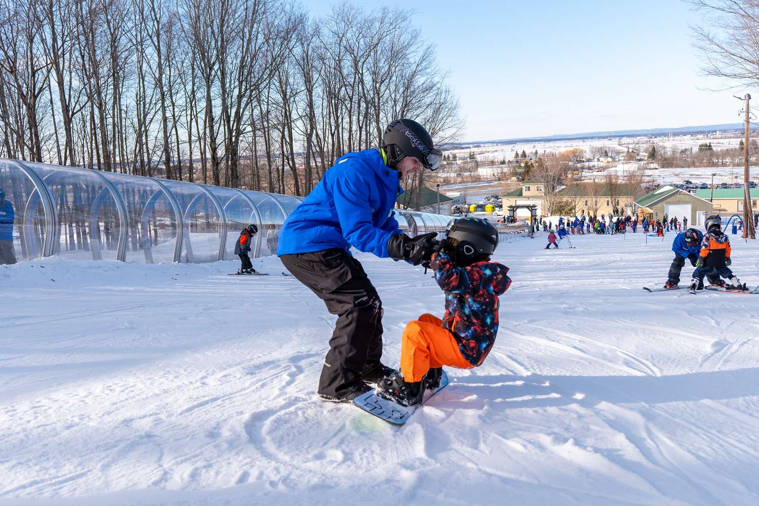 A snowboarding instructor and their student — Mont Rigaud, ski resort, snowboarding, backcountry skiing, mountain biking and hiking, family-friendly, in Rigaud, Quebec, near Montreal
